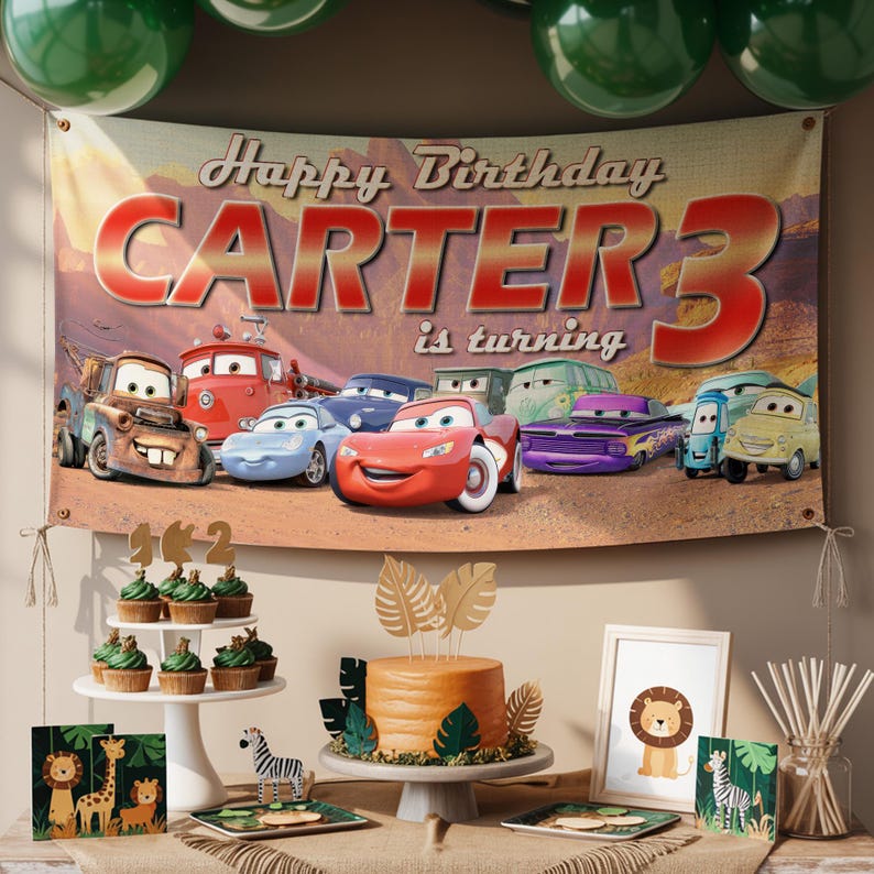 May include: A birthday party scene with a banner that reads "Happy Birthday CARTER 3 is turning." The banner features cartoon cars. There are cupcakes, a cake, and animal-themed decorations. Green balloons are at the top.
