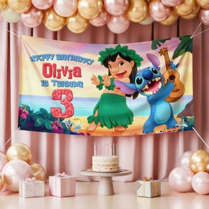May include: A banner with the text "Happy Birthday Olivia is turning 3" featuring Lilo and Stitch characters. The banner is decorated with a beach scene and is part of a birthday party setup with balloons, gifts, and a cake.