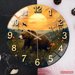 May include: Round wall clock featuring a bear in a field with a sunset backdrop. The clock face has gold numerals and hands. The image includes a bear, flowers, and a bird in flight. The clock is a decorative item for home decor.