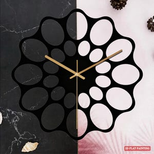 May include: A modern black and white wall clock with gold-colored hands. The clock face features a unique design with oval cutouts. The background is split, with a marble-like pattern on the left and a pink and white design on the right. The text "2D FLAT PAINTING" is visible.