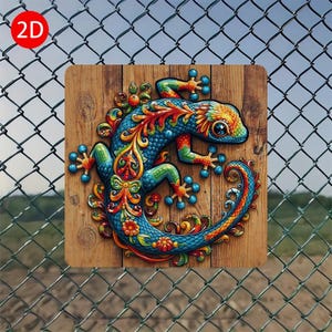 May include: A colorful lizard design on a wooden background. The lizard features blue, green, orange, and yellow hues with intricate patterns. The artwork is mounted on a square wooden plaque, with a red circle labeled "2D" in the upper left corner.