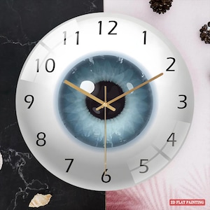 May include: A round wall clock with a unique design. The clock face features a blue iris with gold-colored hands and black numerals. The clock is a decorative piece with the text "2D FLAT PAINTING" in the bottom right corner.