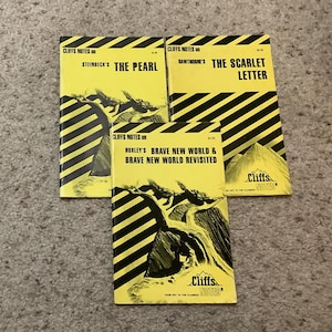 May include: A collection of vintage Cliffs Notes study guides. The covers are yellow with black diagonal stripes and feature titles like "The Pearl" and "The Scarlet Letter." The books have illustrations of mountains and text.