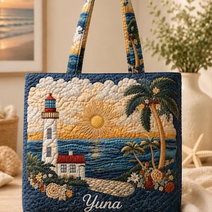 May include: A quilted tote bag depicting a coastal scene with a lighthouse, palm trees, and a setting sun. The bag has a navy blue background with embroidered details and the name "Yuna". The handles are patterned with clouds and trees.