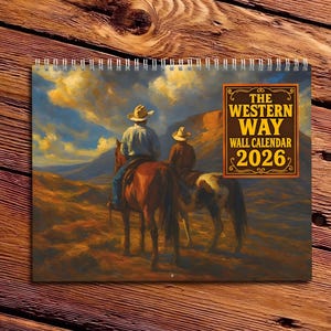 May include: A 2026 wall calendar with a Western theme, showing two cowboys on horseback in a desert scene. The calendar has a spiral binding and the text "THE WESTERN WAY WALL CALENDAR 2026".