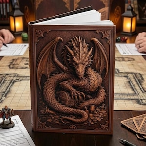 May include: A brown leather-bound journal with a detailed relief carving of a dragon on the cover. The dragon is coiled around a treasure chest. The journal is open, revealing blank white pages.