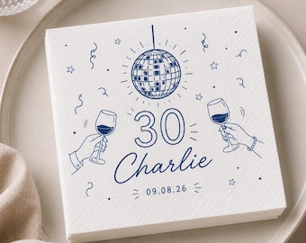 May include: A square white paper napkin featuring a dark blue line art design of a disco ball, two hands holding wine glasses, confetti, and stars. The text reads 30, Charlie, and the date 09.08.26 in a clean, centered font arrangement.