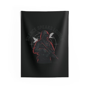 Op de afbeelding: Zwarte wandtapijt met een figuur met capuchon die een geweer, een doel en twee duiven vasthoudt. De tekst "SILENCE SPEAKS LOUDER" is in grijs boven de figuur gebogen. De figuur en de tekst zijn rood gemarkeerd.