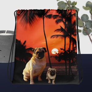 Pugs on sunset beach drawstring bag