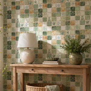 May include: A wooden console table with two drawers, a woven basket, and a decorative vase. A lamp with a white shade sits on the table. The wall behind the table is covered in square tiles with a floral pattern.