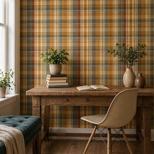 May include: A cozy interior scene featuring a wooden desk with books, plants, and a chair. The wall is covered in a plaid wallpaper with shades of gold, blue, and red. A green bench with a blanket sits near a window.