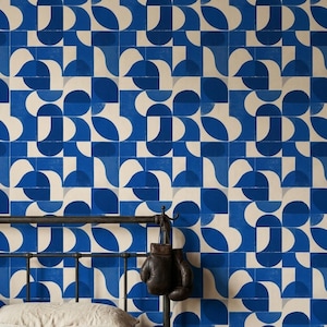 May include: Wallpaper featuring a repeating geometric pattern of deep blue and cream-colored shapes. The design consists of interlocking semi-circles and squares arranged in a grid, creating a bold, high-contrast visual effect across the wall surface.