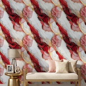 May include: Abstract wallpaper with a marble design featuring red, white, and gold accents. The pattern is diagonal and repeated across the surface. The image also shows a gold side table, a bench, and pillows.