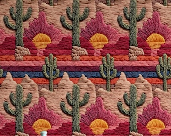 Könnte beinhalten: Eine türkisfarbene Keramik-Teekanne steht vor einer farbenfrohen, gestickten Wüstenlandschaft. Die Szene zeigt grüne Kakteen, rosa Blüten und ein Sonnenuntergangsdesign. Der Hintergrund hat horizontale Streifen in Rot-, Orange- und Blautönen.