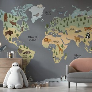 May include: A colorful world map mural with illustrated animals and continents. The map features a gray background with continents in tan, green, and blue. Animals include a bear, moose, lion, giraffe, and panda. A dresser, lamp, and chair are in the foreground.