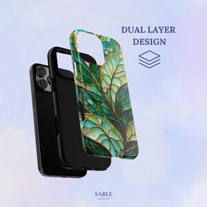 May include: A black phone case with a dual-layer design, featuring a vibrant green and gold leaf pattern. The case is shown separated from a black phone, with the text "DUAL LAYER DESIGN" visible.