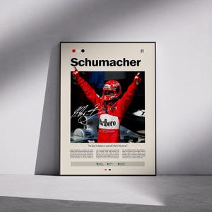 Pode incluir: A framed poster with Michael Schumacher in a red racing suit, celebrating a victory. The poster includes the name "Schumacher" and the quote "You have to believe in yourself, that's the secret."