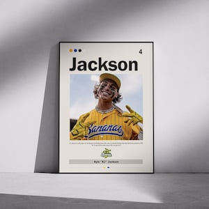 May include: A framed poster featuring a smiling baseball player in a yellow and blue uniform with the word "Bananas" on the front. The poster has the name "Jackson" in large text at the top. The player is wearing a baseball cap and gloves.