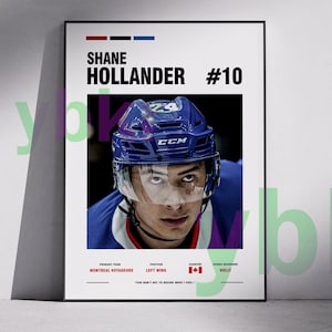 May include: A framed poster featuring hockey player Shane Hollander, wearing a blue helmet with the number 24. The poster includes the text "SHANE HOLLANDER #10", team information, and a quote. The background is white.