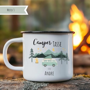 May include: White enamel camping mug with a black rim and handle. The mug features a design with a camper van, mountains, trees, and the text "Camper Tasse Von Andre". A campfire and stars are also included in the design.
