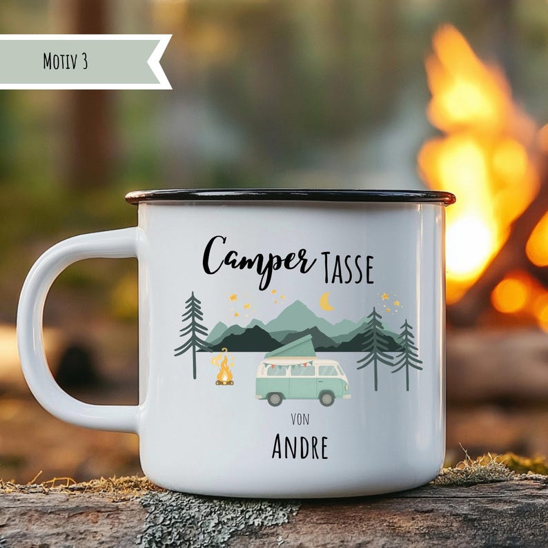 May include: White enamel camping mug with a black rim and handle. The mug features a design with a camper van, mountains, trees, and the text "Camper Tasse Von Andre". A campfire and stars are also included in the design.