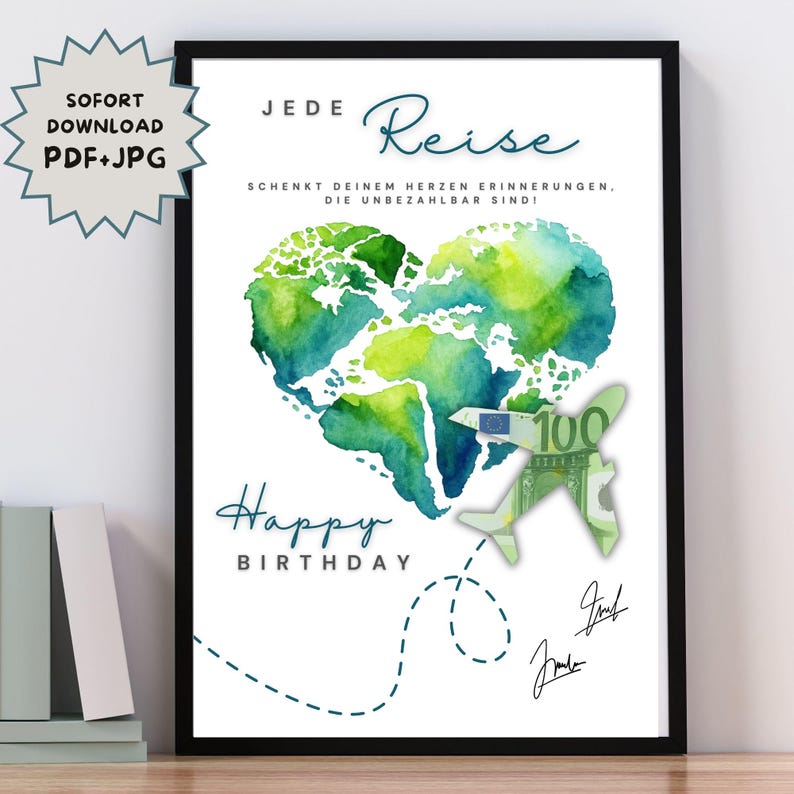 May include: A framed print with a white background features a watercolor heart-shaped world map in shades of green and blue. The words "Happy Birthday" are written below the map, with German text above. A paper airplane made of a 100 Euro note is also included.