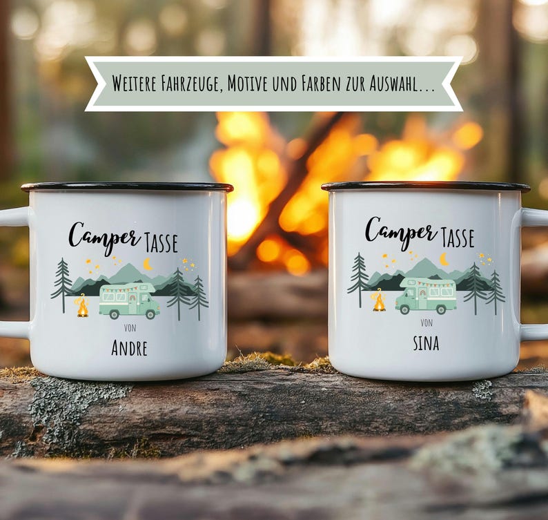 May include: Two white enamel camping mugs with black rims and handles. Each mug features a green camper illustration, trees, and the text "Camper TASSE". One mug says "VON ANDRE" and the other says "VON SINA". The background shows a campfire.