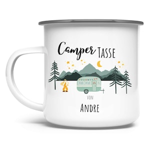 May include: White enamel camping mug with a black rim and handle. The mug features a camping scene with a teal camper, mountains, trees, a campfire, and the text "Camper Tasse" and "Von Andre" in black script.