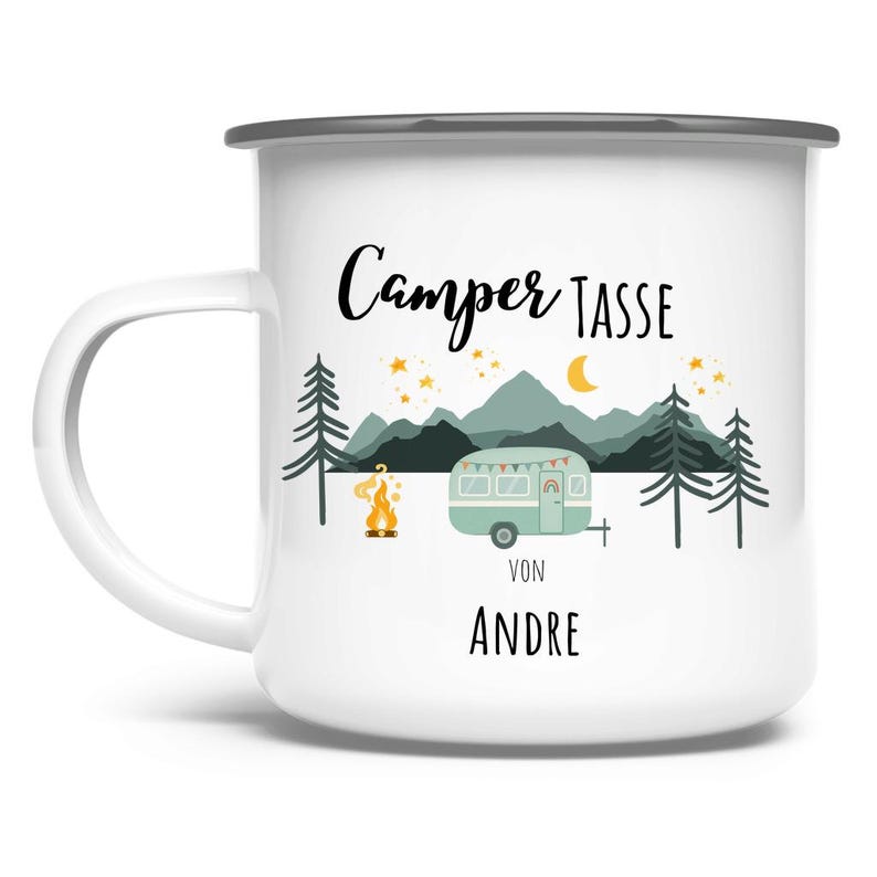 May include: White enamel camping mug with a black rim and handle. The mug features a camping scene with a teal camper, mountains, trees, a campfire, and the text "Camper Tasse" and "Von Andre" in black script.