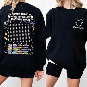 a black sweatshirt with a message and a list of Disney characters printed on it.