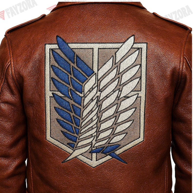 K&ouml;nnte beinhalten: Braune Lederjacke mit einem gro&szlig;en, gestickten Emblem auf dem R&uuml;cken. Das Emblem zeigt blaue und wei&szlig;e Fl&uuml;gel in einem rechteckigen Rahmen. Die Jacke hat ein klassisches Design mit Schulterklappen.