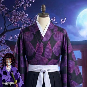 May include: A purple and black kimono-style robe with a white collar and belt, displayed on a mannequin. The robe features a repeating pattern of purple shapes against a black background. The outfit includes a black skirt. A character illustration is in the lower left.
