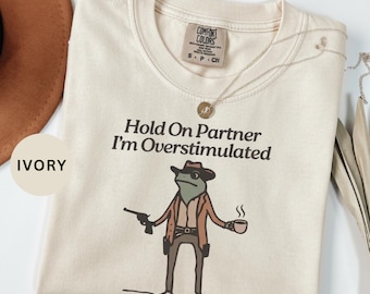 Hold On Partner I'm Overstimulated Shirt | Funny Frog Cowboy Meme Gift | Weirdcore Frog Western Shirt | Comfort Colors Graphic Tee