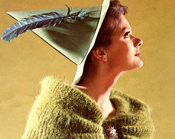 May include: A woman wearing a green knitted sweater with a large, green, pointed hat with a feather. The hat has a white brim. She is looking up and to the right.