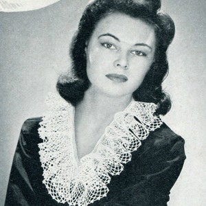 May include: A black and white photo of a woman wearing a white crocheted collar. The collar is a wide, ruffled design with a scalloped edge.