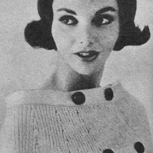 May include: A black and white photo of a woman wearing a knitted sweater with buttons. The sweater has a textured pattern and is a light color.