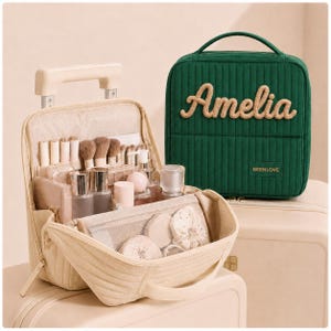 May include: A dark green quilted travel case with the name Amelia in beige script and a beige travel case with an open top revealing various makeup brushes, bottles, and a mesh pocket. Both cases feature a vertical quilted texture and a top handle.