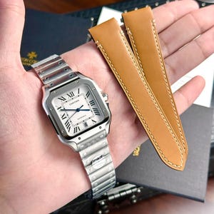 Reloj Cartier Santos de Cartier con esfera blanca de 40 mm, estuche completo, papel y etiqueta.