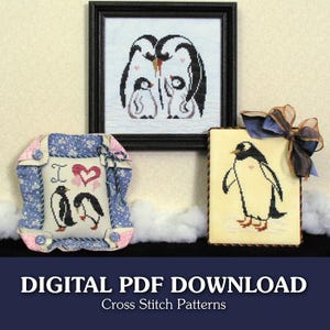May include: Three cross-stitch penguin patterns are displayed. One is framed, showing a penguin family. Another is a pillow with the text "I ❤️" and two penguins. The third is a single penguin with a bow.