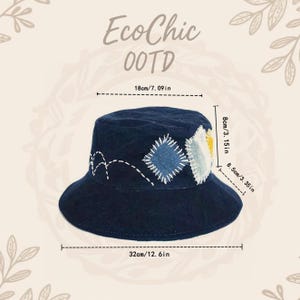 以下が含まれることがあります： 装飾パッチと白いステッチが施されたネイビーブルーのバケットハット。帽子の直径は32cm、上部の幅は18cm、高さは8cmです。「EcoChic OOTD」という文字が見えます。