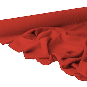 May include: A roll of vibrant red fabric, partially unrolled to reveal soft folds. The fabric is a solid color, with a smooth texture. The image is set against a white background, highlighting the rich color and texture of the material.
