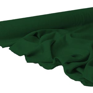 May include: A roll of dark green fabric with a smooth texture. The fabric is partially unrolled, revealing soft folds and draping. The color is a deep, rich shade of green.