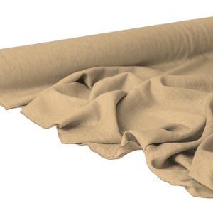 May include: A roll of beige fabric with a natural, textured appearance. The fabric is partially unrolled, displaying soft folds and a raw edge. The neutral color and texture suggest it could be used for various sewing and crafting projects.