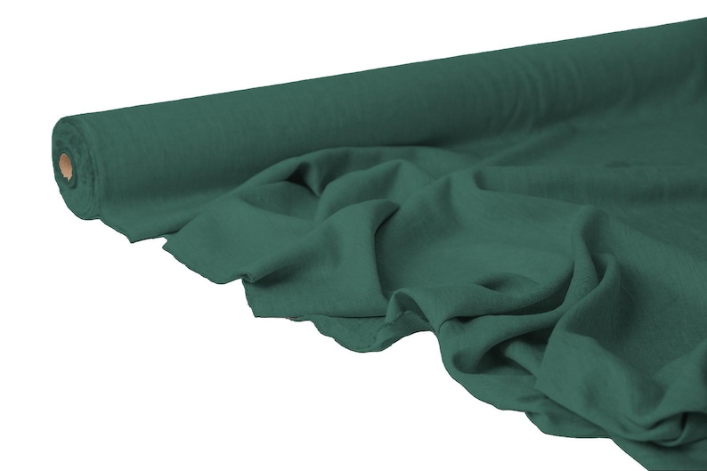 May include: A roll of dark teal fabric, partially unrolled to reveal the soft texture. The fabric is draped, showing its flexibility and potential for various sewing projects. The roll's core is visible, adding contrast to the solid color.