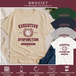 May include: A beige short-sleeve t-shirt featuring a maroon graphic with the text Executive Dysfunction University, Class of Eventually, and Ønquiet. The design includes a central crest with laurel leaves and the text Honor Program.