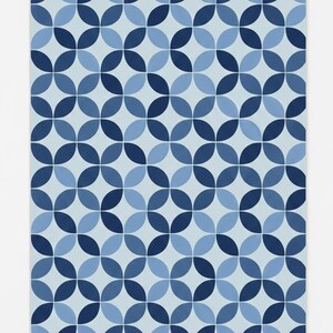 May include: A geometric pattern of overlapping circles in various shades of blue, forming a symmetrical design. The pattern is set against a light blue backdrop, providing a modern and clean aesthetic. Suitable for various home decor items.