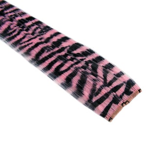 May include: Pink and black zebra print hair extension. The hair extension is made of synthetic hair and is designed to be used for adding length and volume to hair.