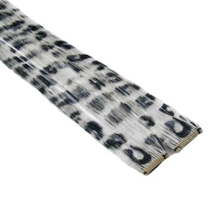May include: A set of black and white leopard print hair extensions with a clip-in design.