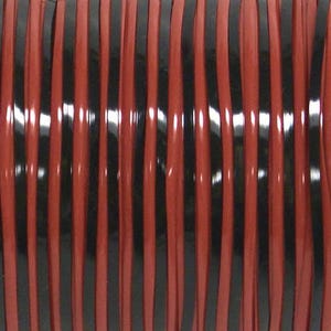 May include: A spool of cord featuring alternating vertical strands of glossy black and matte terracotta red. The material is arranged in tight, parallel lines, creating a consistent striped pattern across the entire surface of the cylindrical spool.