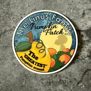 May include: A round sticker with a pumpkin patch theme. The sticker features a yellow pumpkin with green leaves, a full moon, and the text "The Linus Family Pumpkin Patch". The text "The Greatest Pumpkins around" is also included.